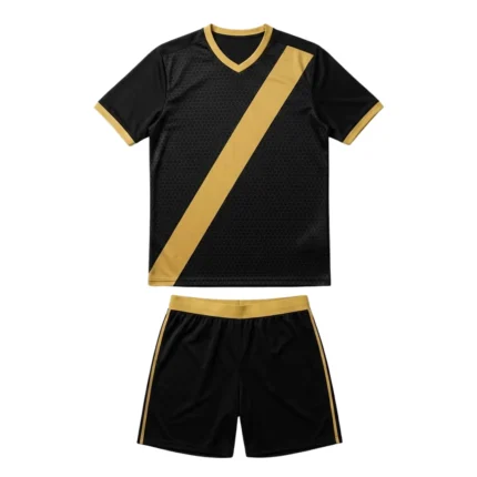 Front view of the Shadow Phantom custom soccer kit in jet black and warm gold, featuring a sublimated hexagonal geometric pattern, a diagonal gold sash, and V-neck collar for professional sports teams