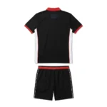 Back view flat lay of the Match Point black custom padel polo shirt with white side panels and red waistband shorts