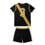 Back view flat lay of the Smash Elite black custom volleyball jersey featuring gold number 3 across a diagonal sash with matching shorts